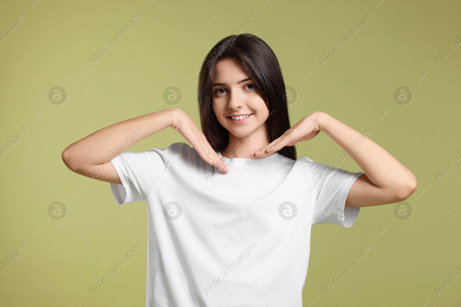 Photo of Portrait of cute teenage girl on olive background