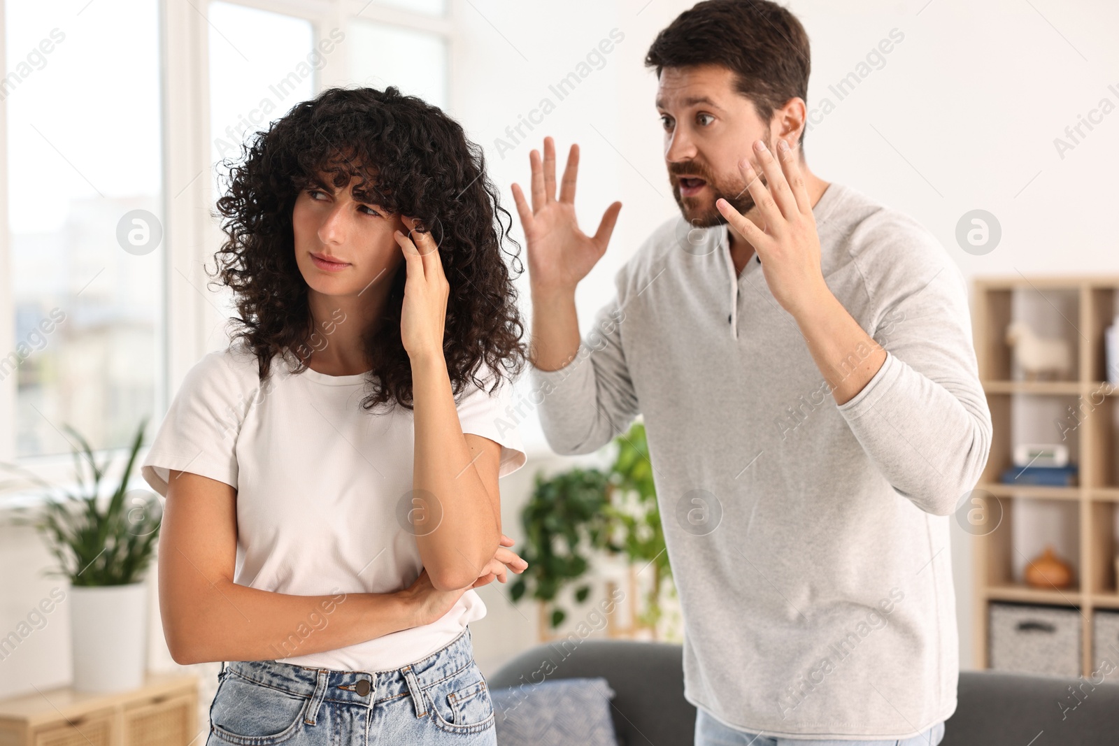 Photo of Emotional couple having quarrel at home. Relationship problems