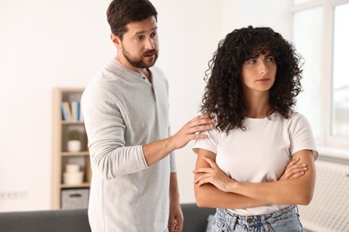 Photo of Couple having quarrel at home. Relationship problems