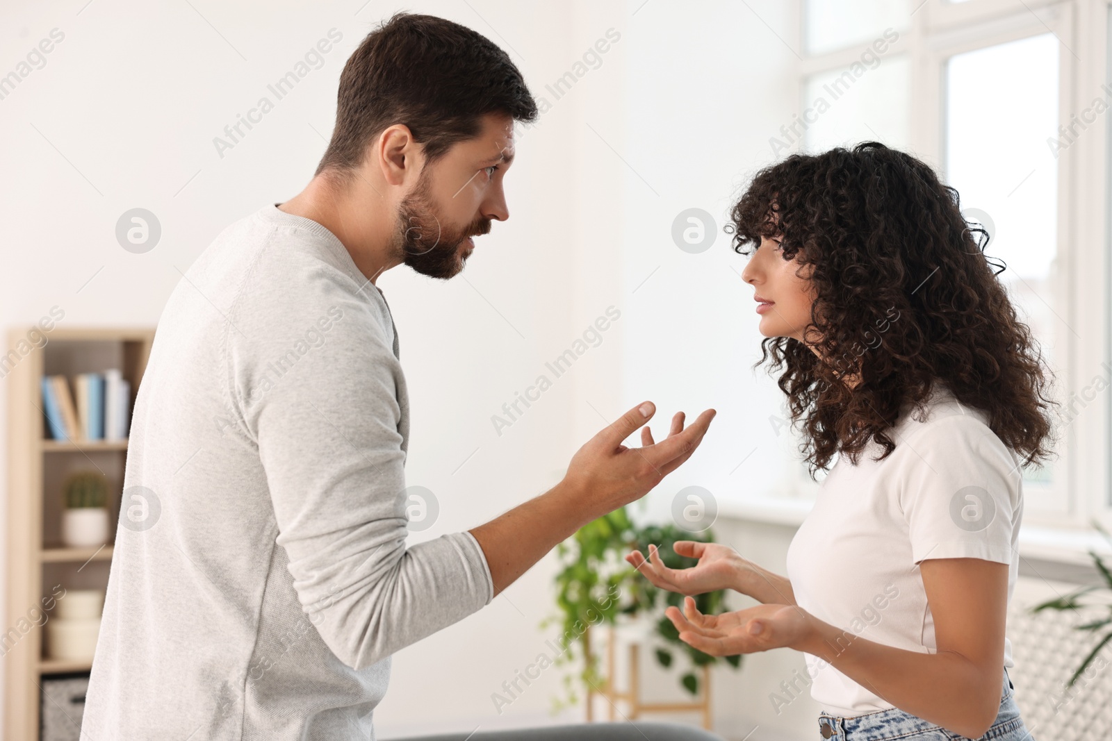 Photo of Emotional couple arguing at home. Relationship problems