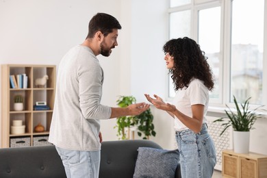 Photo of Emotional couple arguing at home. Relationship problems