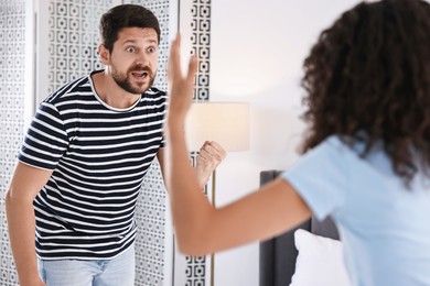 Photo of Emotional couple arguing at home. Relationship problems