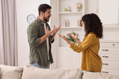 Photo of Emotional couple arguing at home. Relationship problems