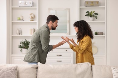 Photo of Emotional couple arguing at home. Relationship problems