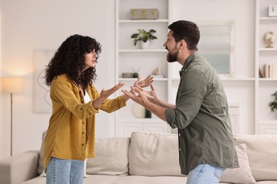 Photo of Emotional couple arguing at home. Relationship problems