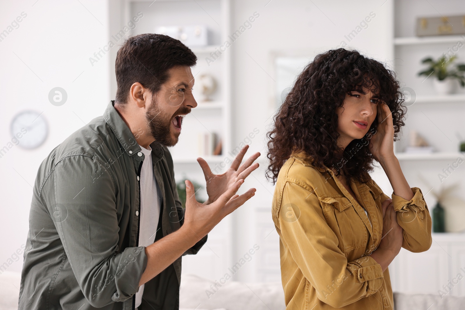 Photo of Emotional couple having quarrel at home. Relationship problems