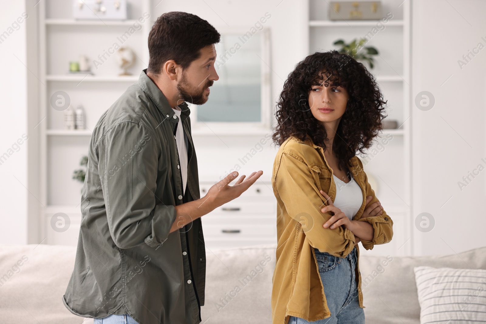 Photo of Emotional couple having quarrel at home. Relationship problems