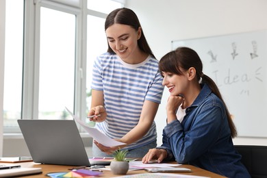 Photo of Happy young designers working together in office