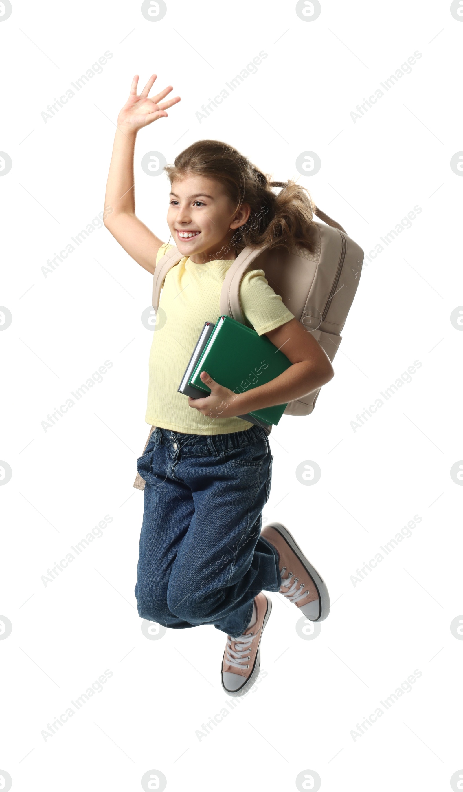 Photo of Girl with backpack and books jumping on white background