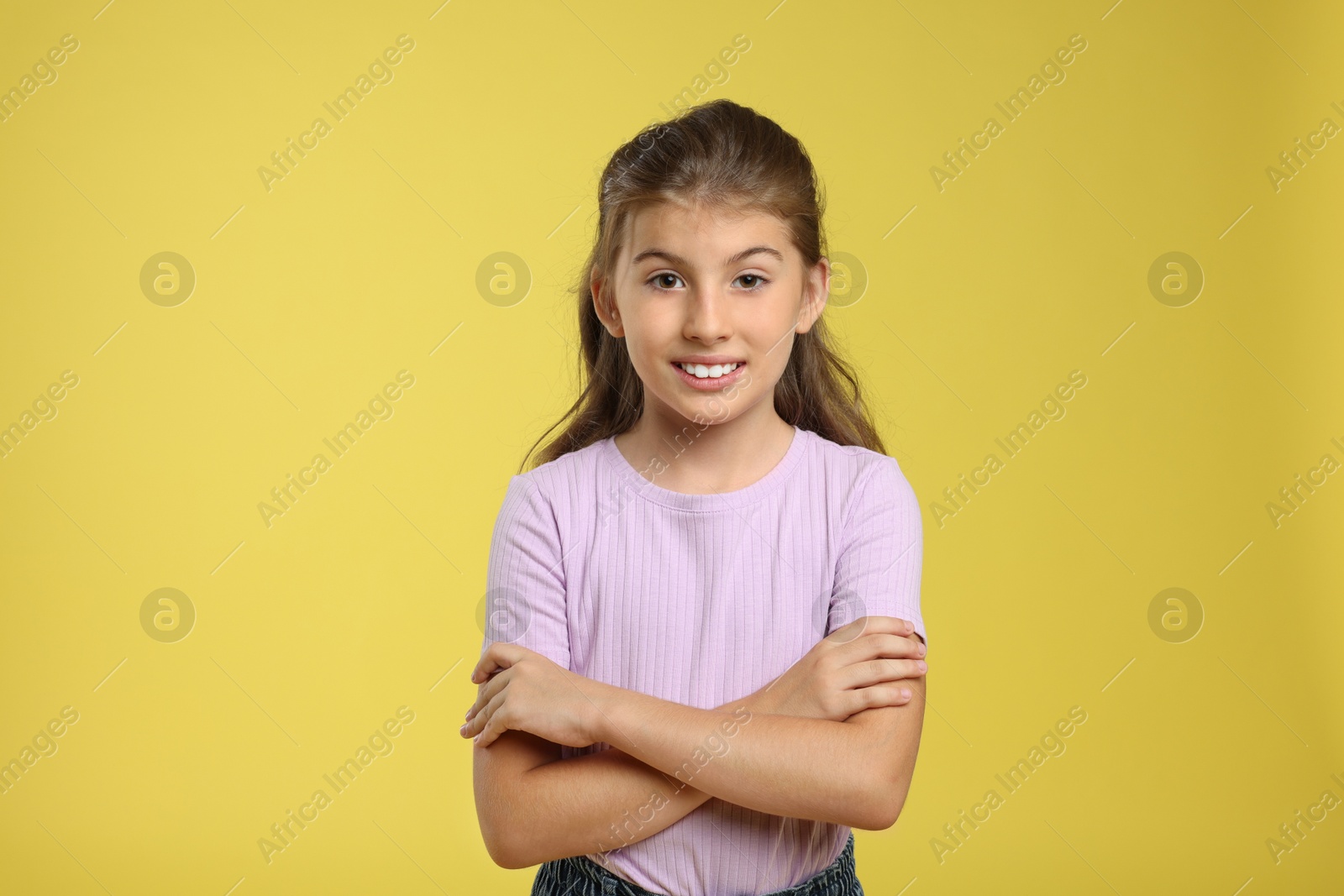 Photo of Portrait of cute girl on yellow background