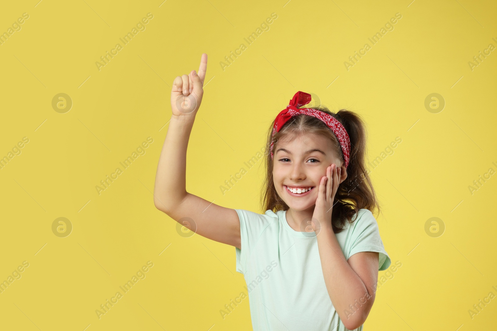 Photo of Portrait of cute girl on yellow background