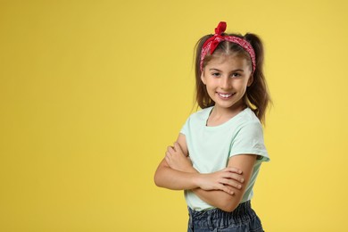 Photo of Portrait of cute girl on yellow background