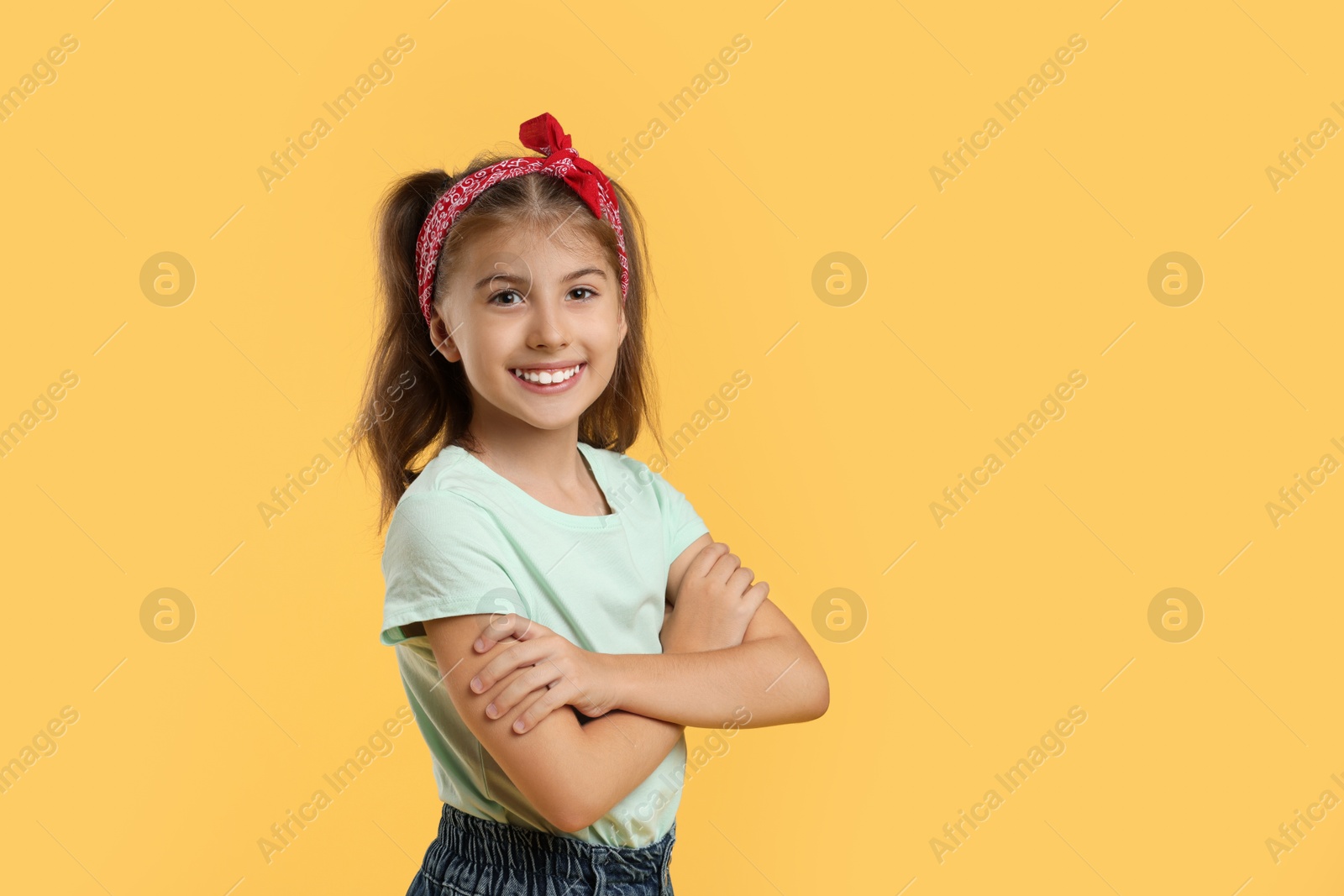 Photo of Portrait of cute girl on yellow background