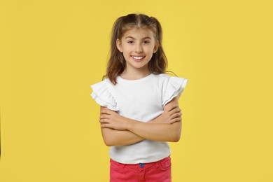 Photo of Portrait of cute girl on yellow background