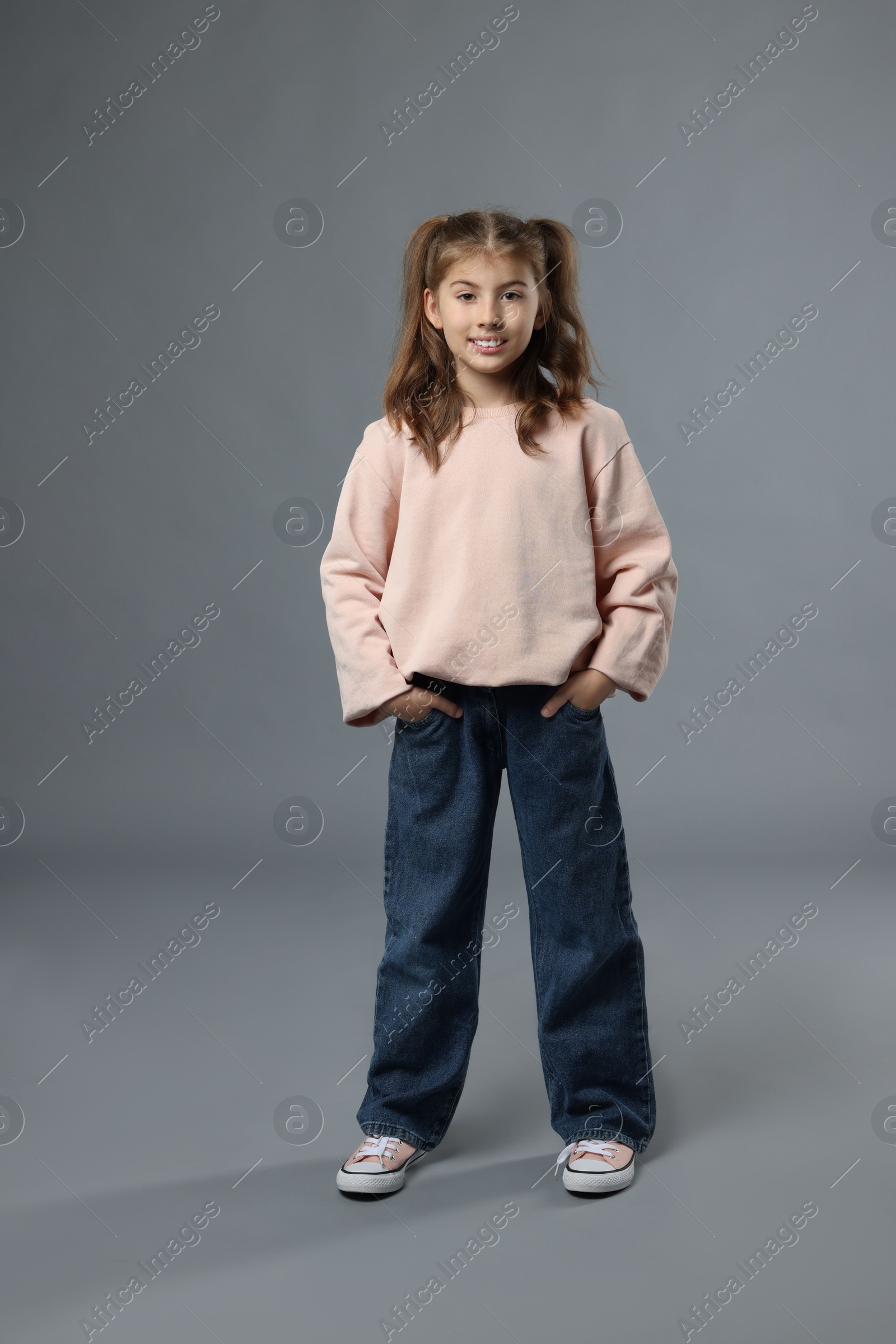 Photo of Full length portrait of cute girl on grey background