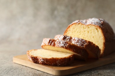 Photo of Freshly baked sponge cake on light grey table, closeup