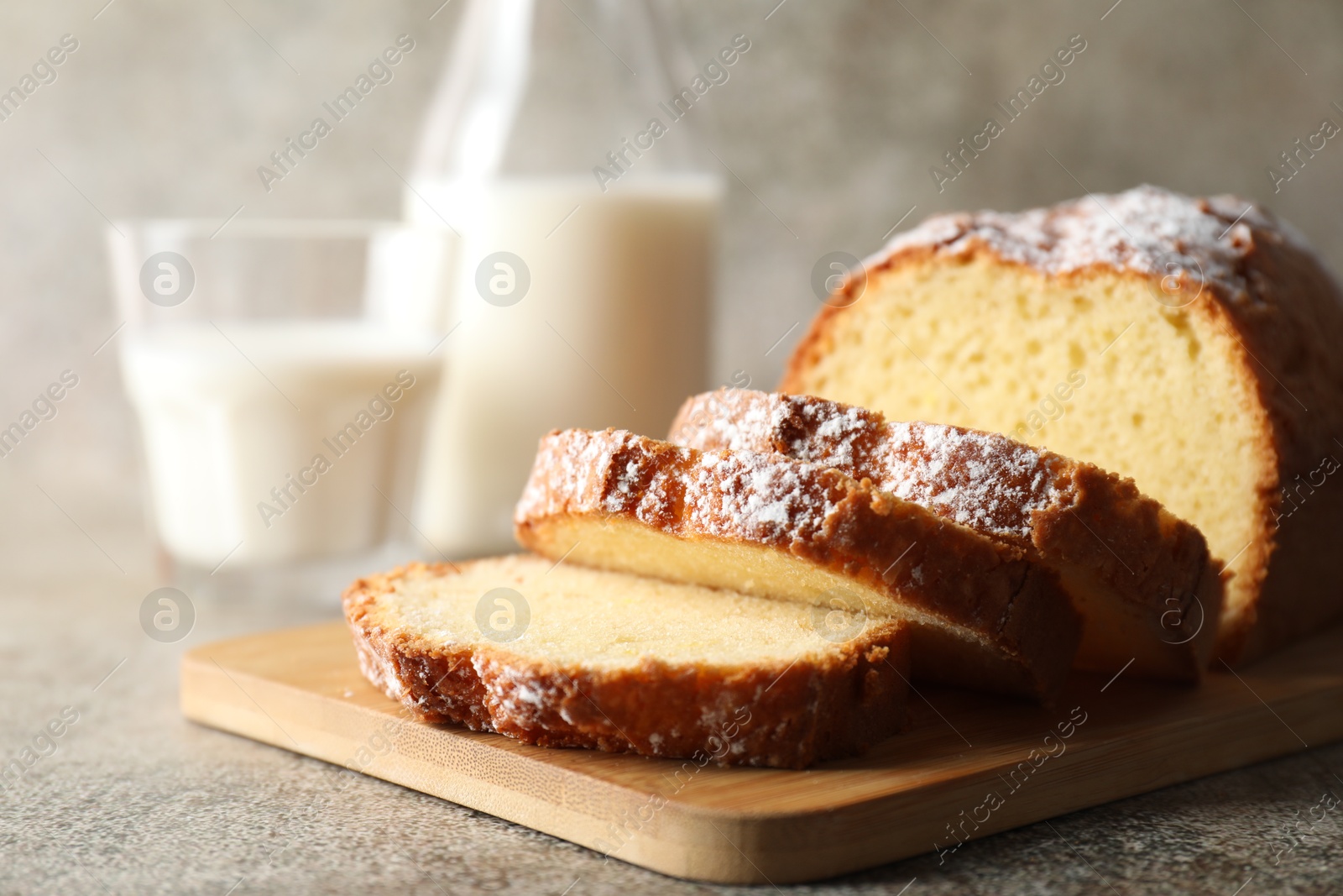 Photo of Freshly baked sponge cake on light grey table, closeup