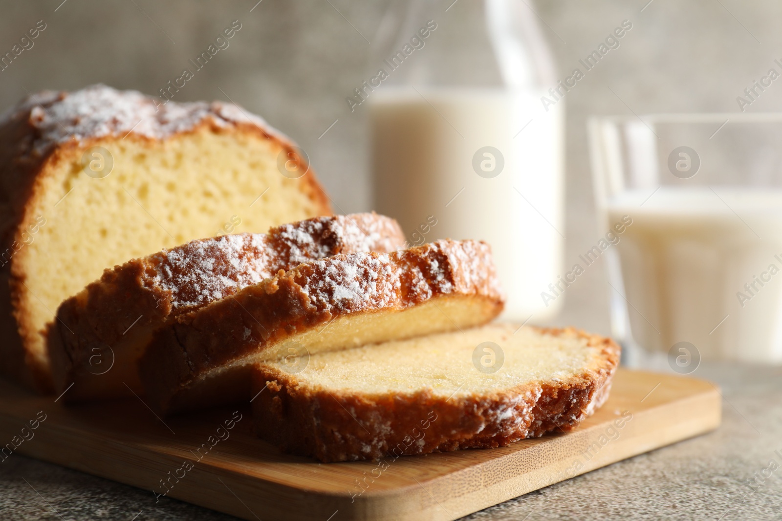 Photo of Freshly baked sponge cake on light grey table, closeup