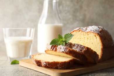 Photo of Freshly baked sponge cake on light grey table, closeup