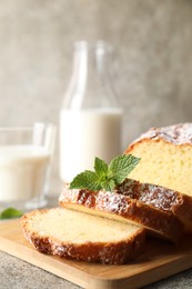 Photo of Freshly baked sponge cake on light grey table, closeup