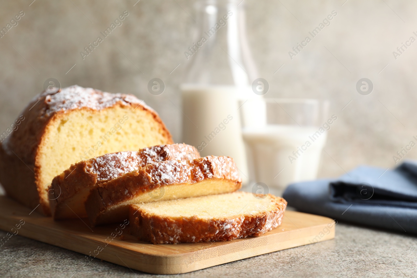 Photo of Freshly baked sponge cake on light grey table, closeup