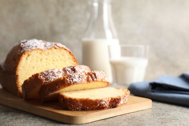 Photo of Freshly baked sponge cake on light grey table, closeup