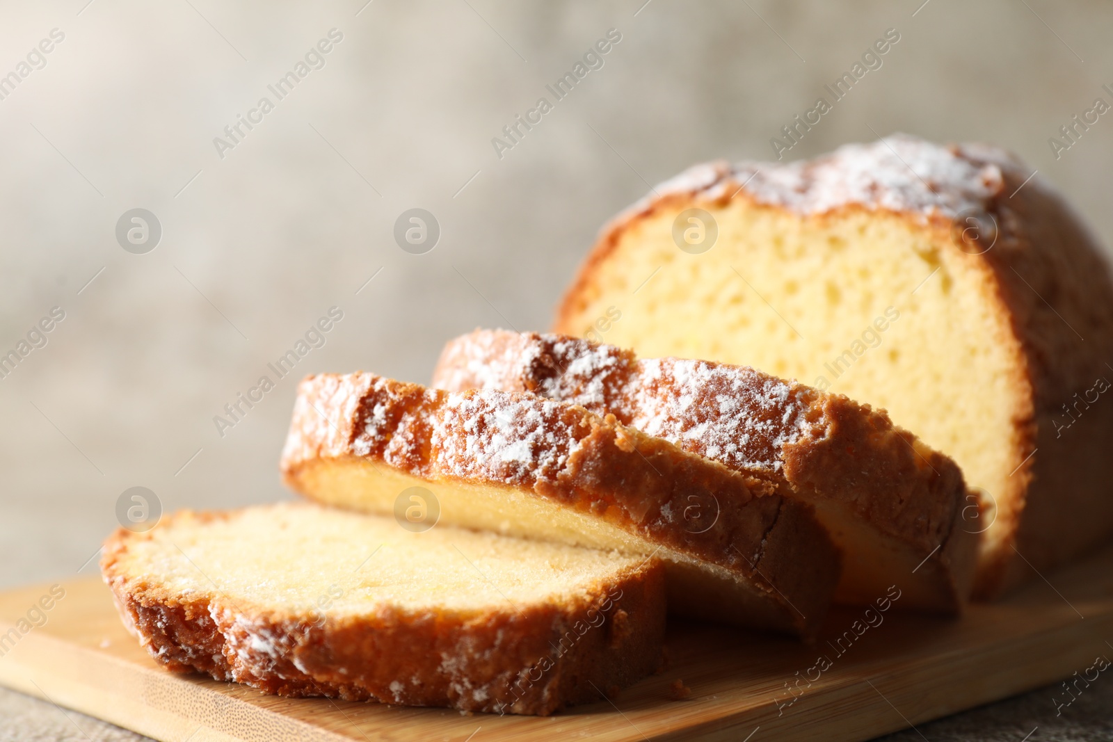 Photo of Freshly baked sponge cake on light grey table, closeup