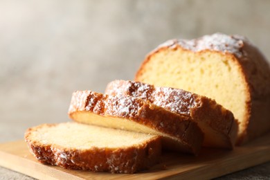 Freshly baked sponge cake on light grey table, closeup