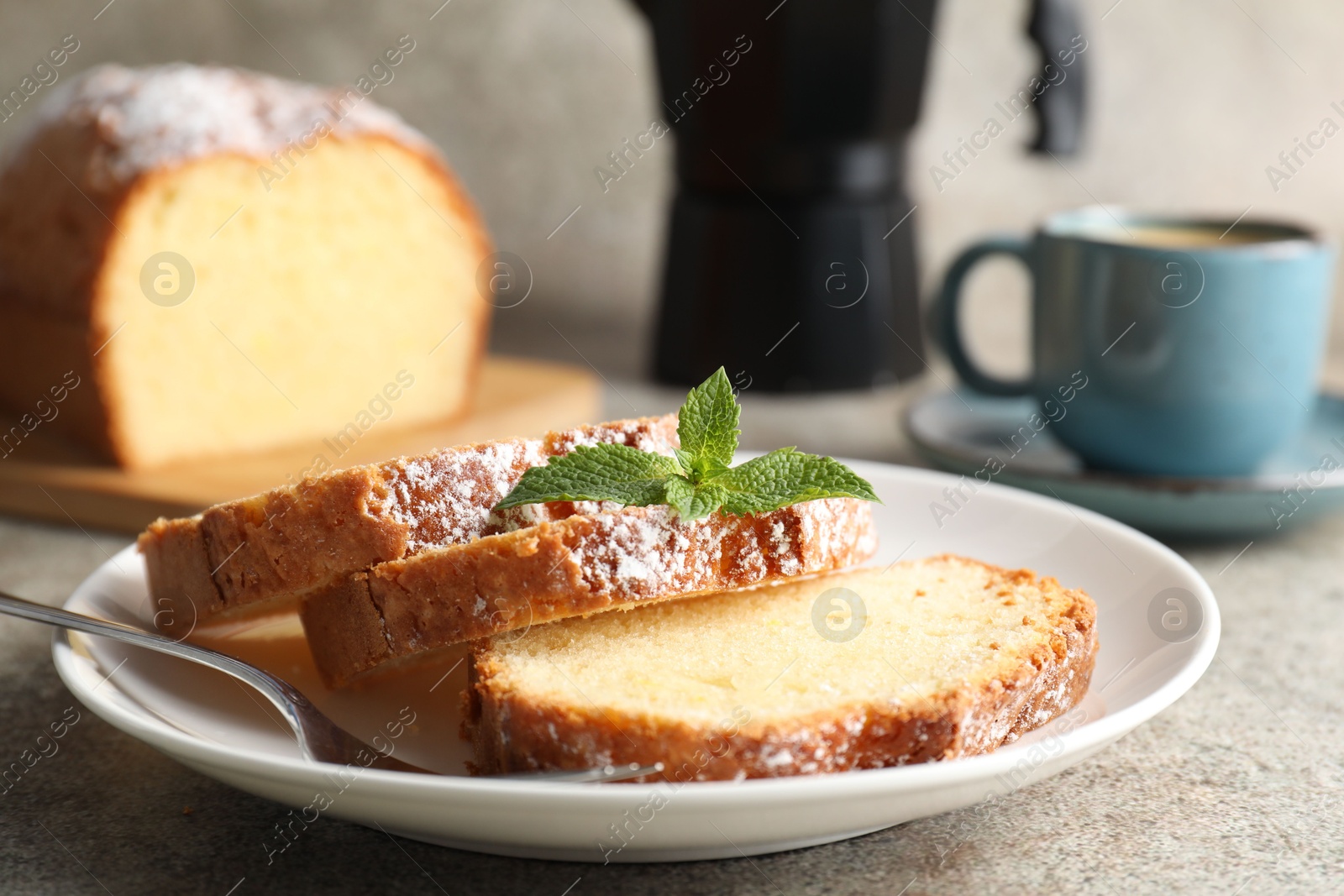 Photo of Freshly baked sponge cake and coffee on light grey table, closeup