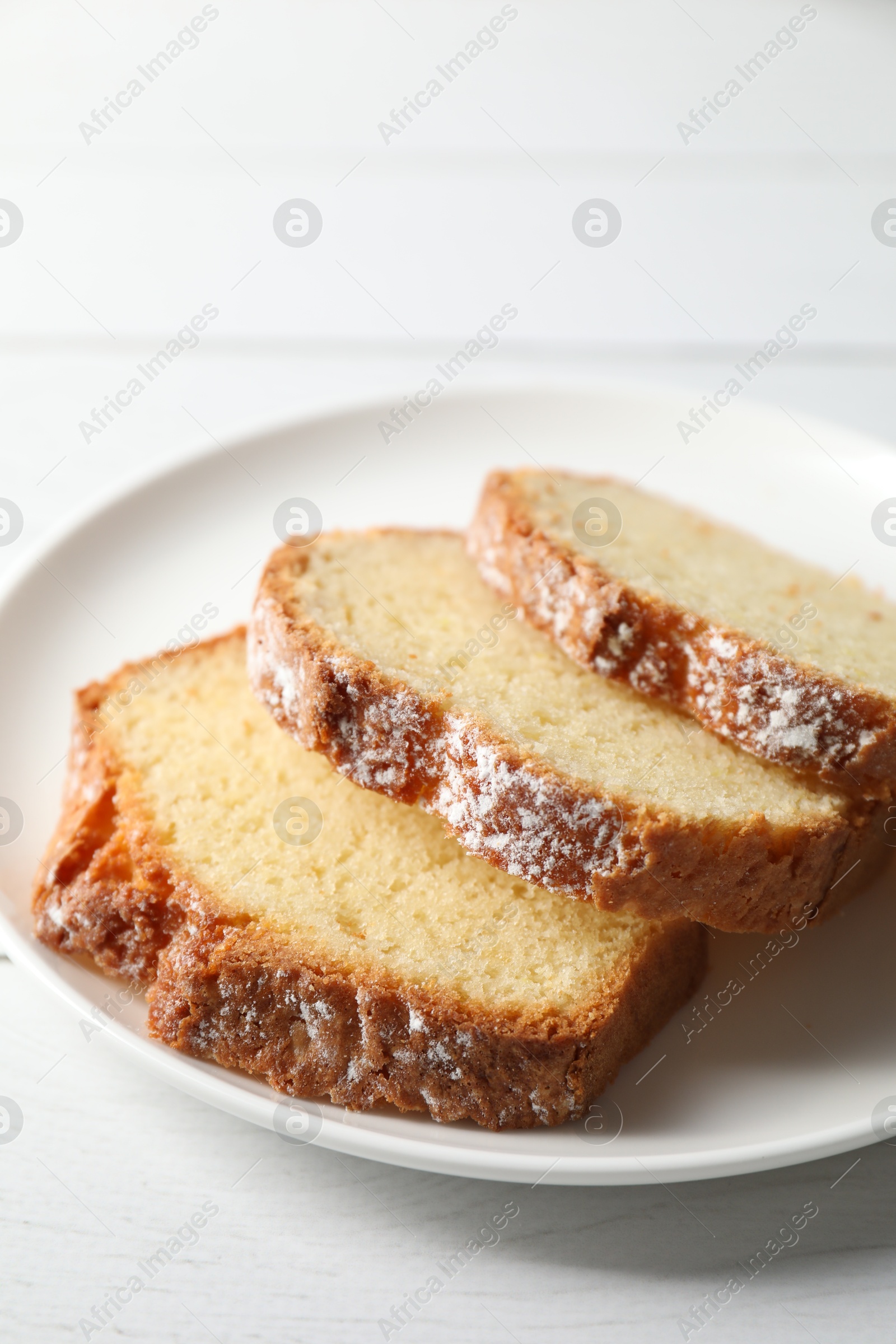 Photo of Freshly baked sponge cake on white wooden table, closeup