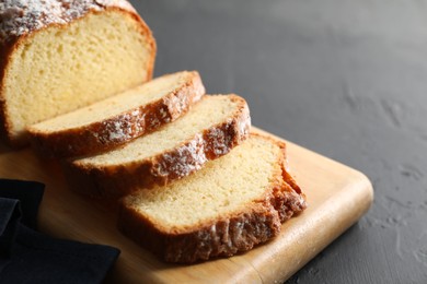 Photo of Freshly baked sponge cake on black table, closeup