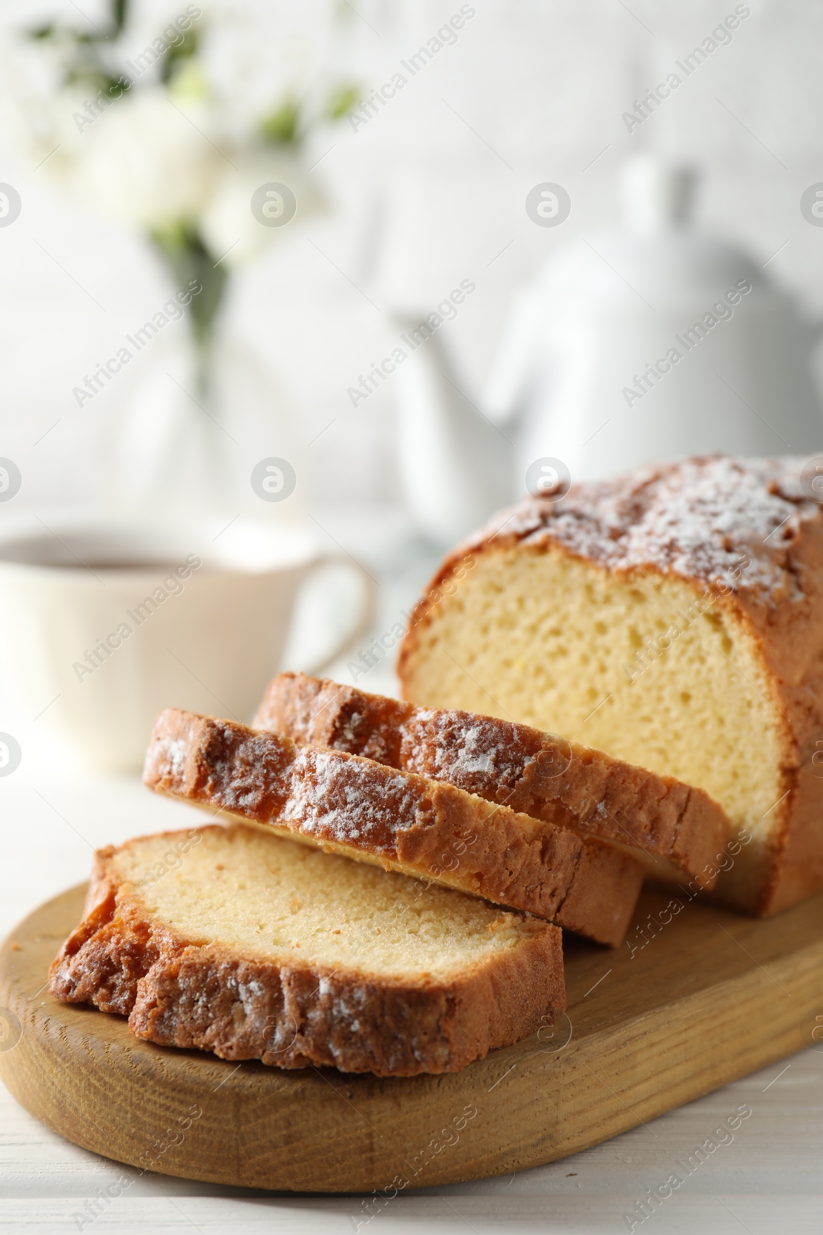 Photo of Freshly baked sponge cake on white wooden table, closeup