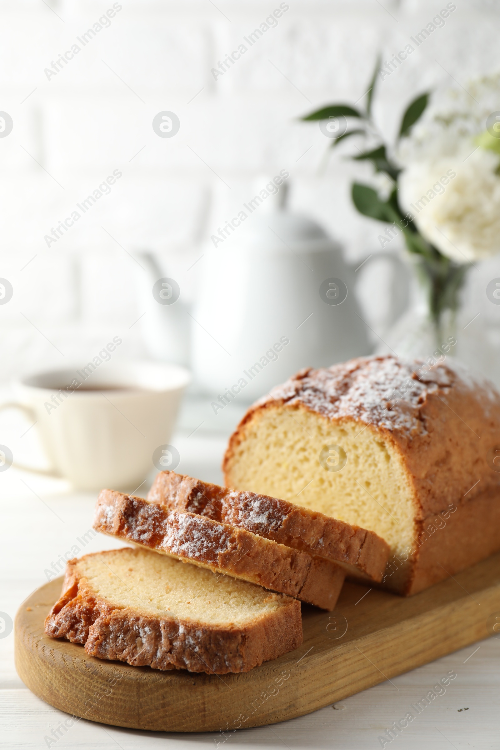 Photo of Freshly baked sponge cake on white wooden table, closeup