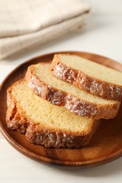 Photo of Freshly baked sponge cake on white wooden table, closeup