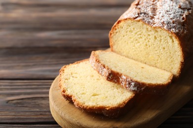 Photo of Freshly baked sponge cake on wooden table, closeup