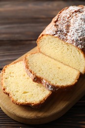 Photo of Freshly baked sponge cake on wooden table, closeup