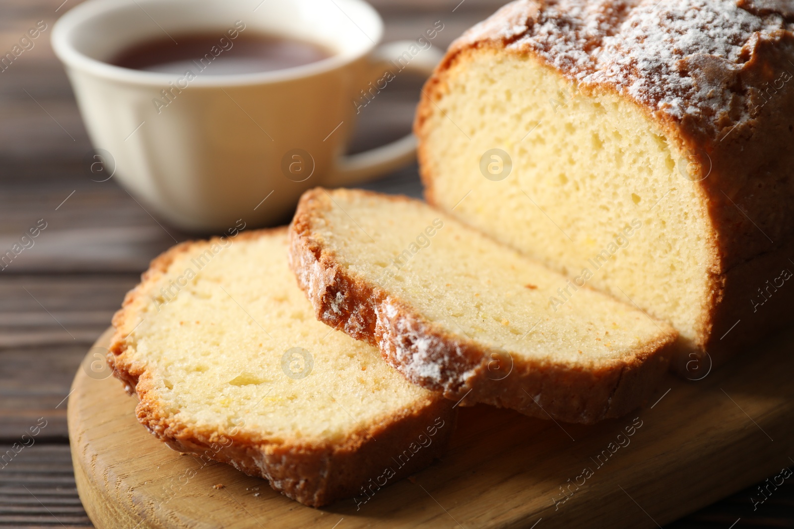 Photo of Freshly baked sponge cake on wooden table, closeup