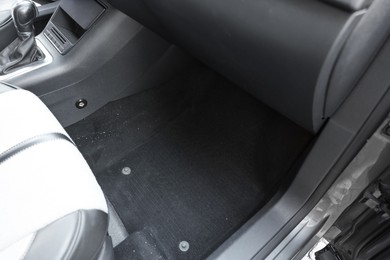 Photo of Black soft car floor mat in auto