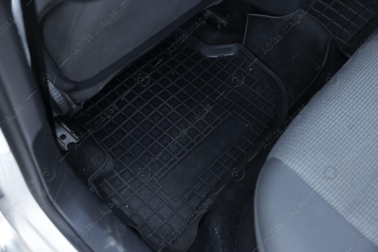 Photo of Black rubber car floor mat in auto