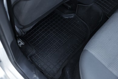 Photo of Black rubber car floor mat in auto