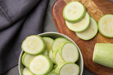 Photo of Fresh cut zucchinis on grey table, flat lay