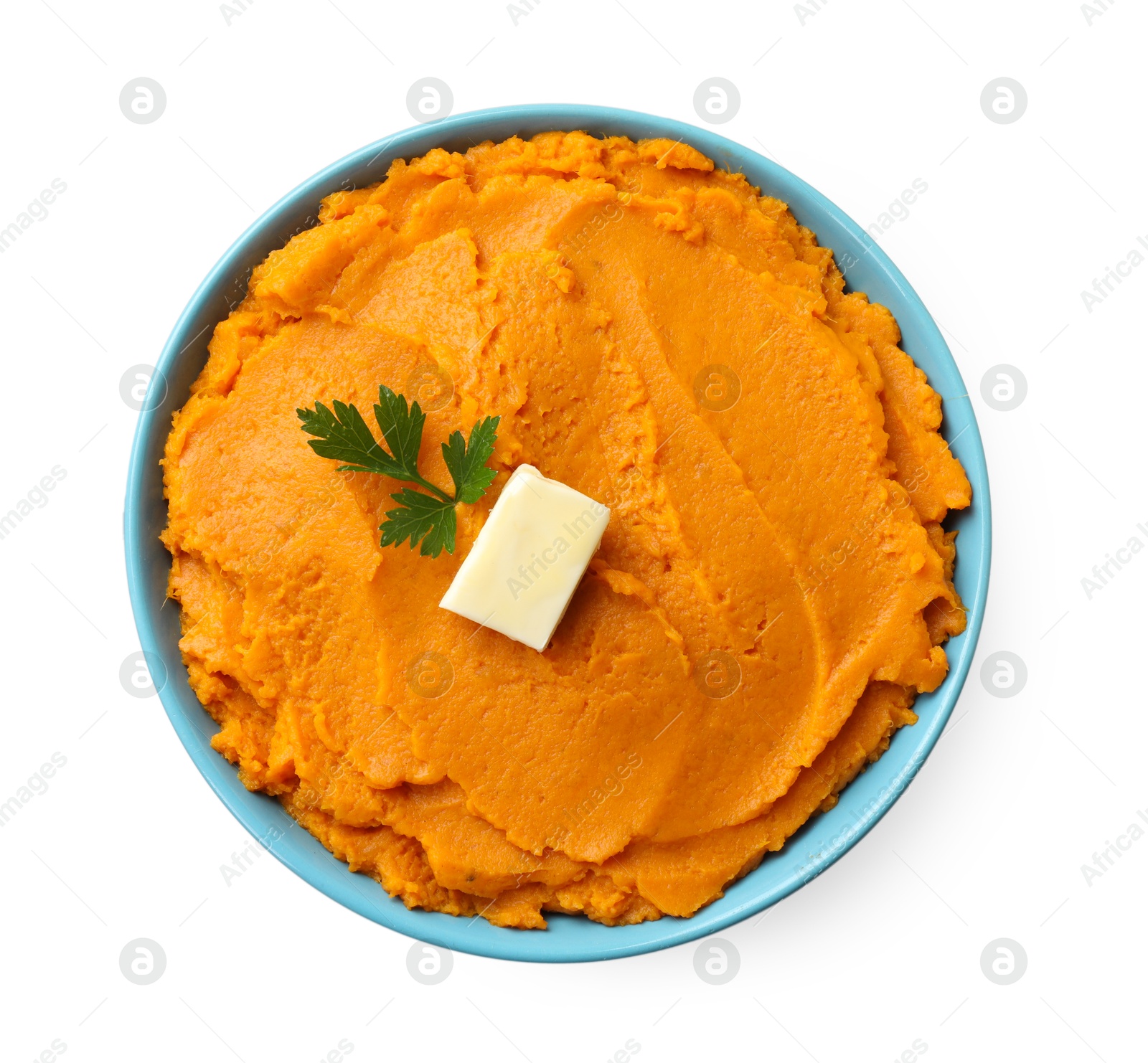 Photo of Tasty mashed sweet potato with butter and parsley in bowl isolated on white, top view