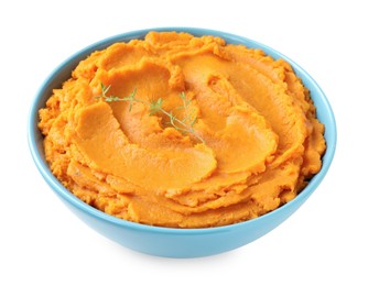 Photo of Tasty mashed sweet potato and thyme in bowl isolated on white