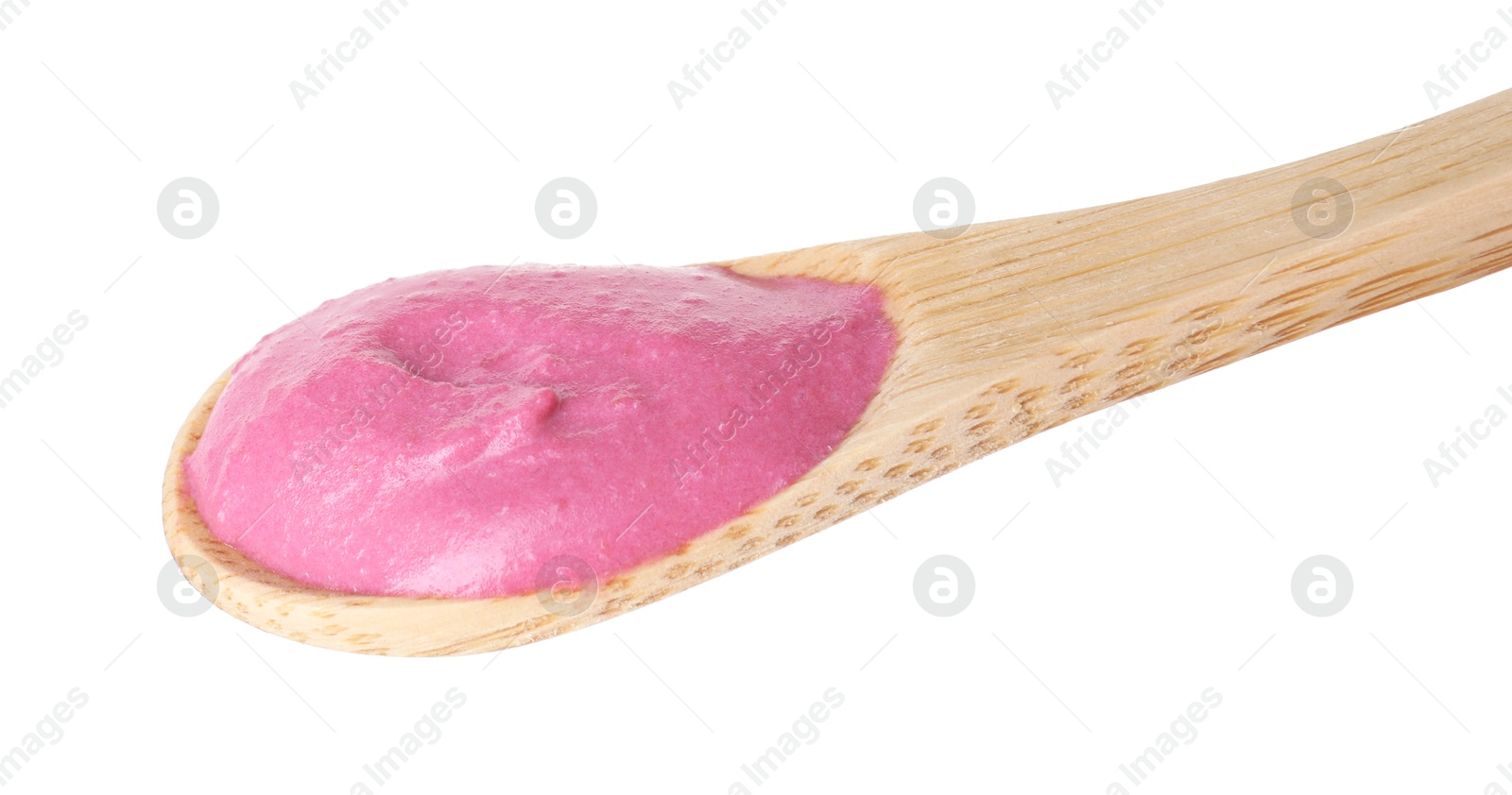 Photo of Tasty beetroot hummus in wooden spoon isolated on white