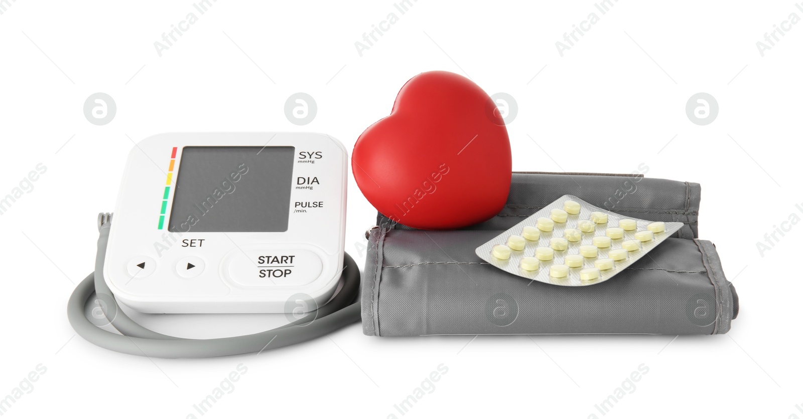 Photo of Blood pressure monitor, pills in blister and red decorative heart isolated on white