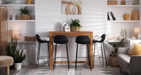 Bar stools near table in room. Interior design