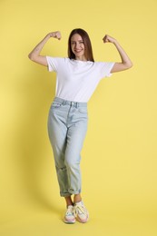 Portrait of happy winner on yellow background