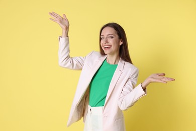 Photo of Portrait of happy winner on yellow background