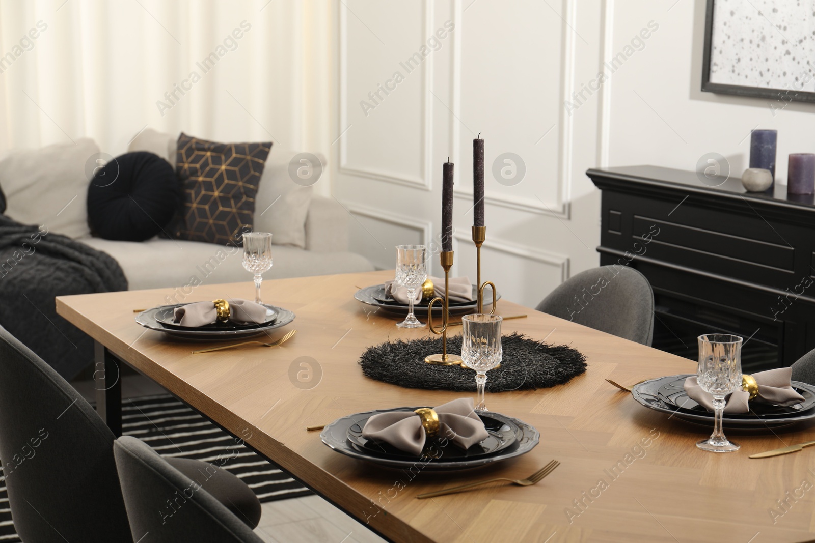 Photo of Stylish table setting with black dishware in dining room