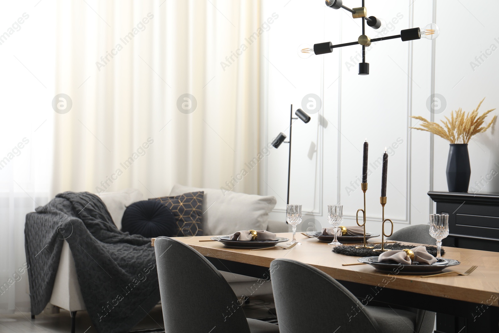 Photo of Stylish table setting with black dishware in dining room